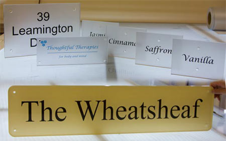 Clear acrylic signs with backing vinyl.