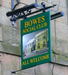 Painted hanging sign panel on hanging bracket with outdoor lighting kit Painted hanging sign panel on hanging bracket with outdoor lighting kit