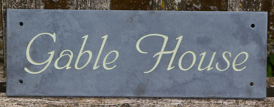 Slate sign with text lichen green