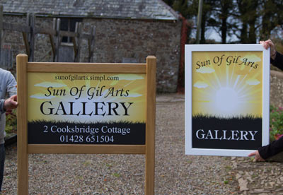 An oak framed entrance sign and a hanging framed sign. Ref 1909.SV.022.