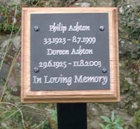 Black engraved plaque on backing board with a metal tree stake Black engraved plaque on backing board with a metal tree stake