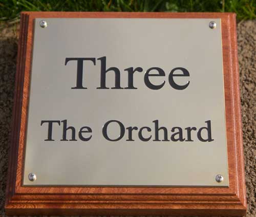 Deep engraved brass plaque on a backing board