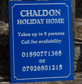 Engraved blue aluminium house sign.