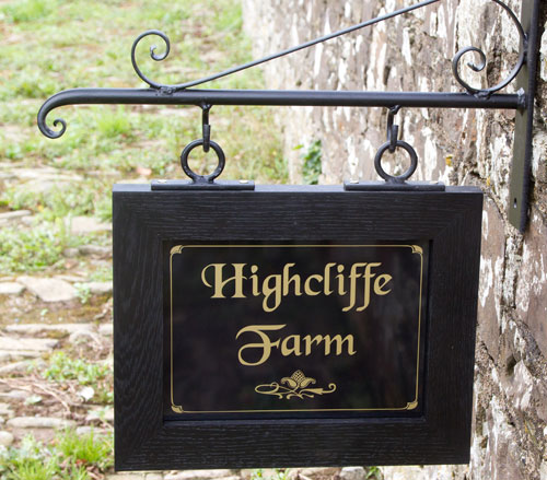 Black oak framed sign with wrought iron bracket