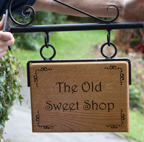 Oak sign with a wrought iron bracket