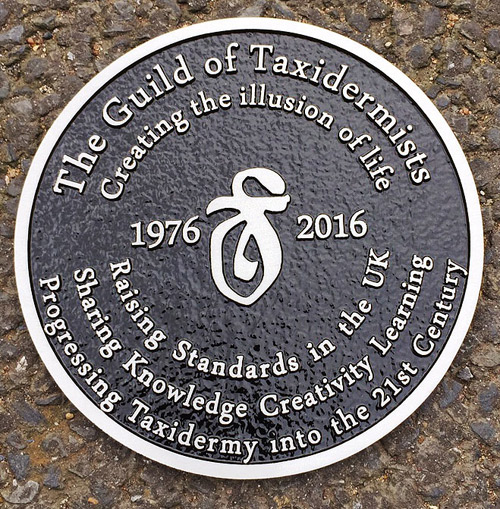 Cast aluminium plaque with a black background