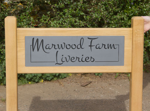 Solid oak panel and posts with slate corian engraved inset.