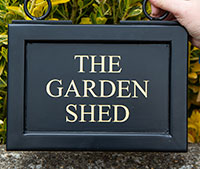 Black framed hanging sign. Black framed hanging sign.