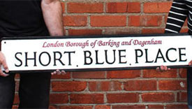 Street sign with raised lettering.