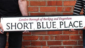 Street sign with raised lettering.