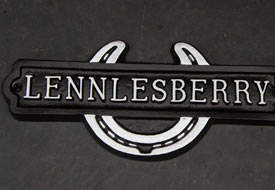 Horseshoe shaped cast aluminium nameplate.