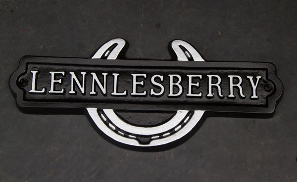 Cast metal horseshoe sign