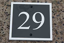 Slate house number with white edge border.