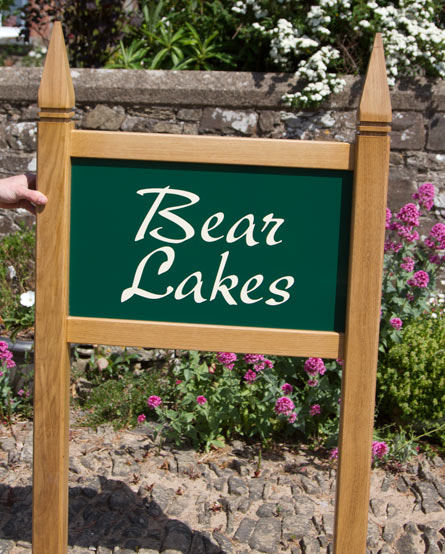 Entrance sign with gothic posts tops.