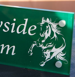 Moss green painted and etched acrylic sign.