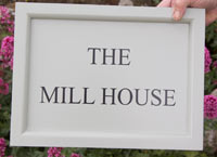 Painted framed house sign.