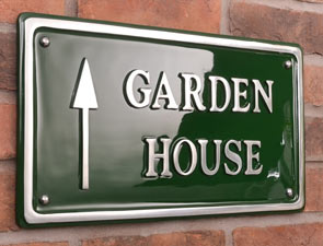 Cast aluminium house sign painted green.