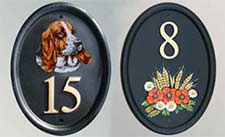 Cast door numbers with hand painted motifs.