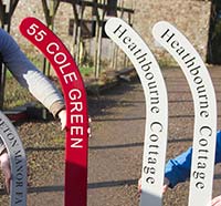 Painted hockey stick entrance signs.