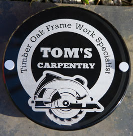 Circular clear acrylic with lasered lettering through black painted background.