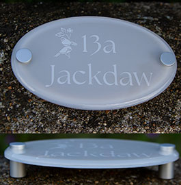 Small oval house sign painted in Farrow & Ball Purbeck Stone with text laser etched and painted white.