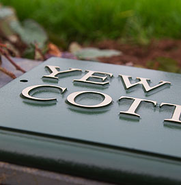 Close up of rectangular sign with gold paint