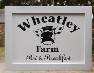 White painted hanging sign