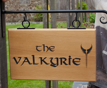 Hanging wooden sign using the font - Valhala.