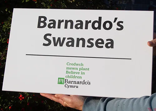 white engraved plaque with logo