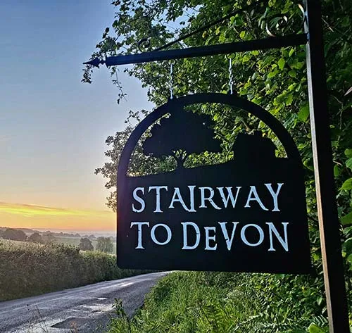 Cut out hanging metal sign in situ. Cut Out Metal Sign