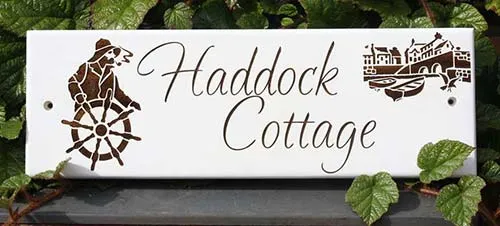 Laser etched through paint into the hardwood Sapele.