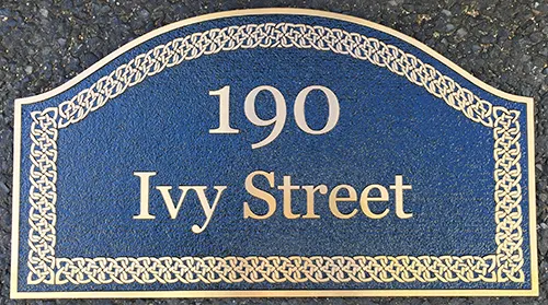 Bronze cast metal sign with gold Celtic border
