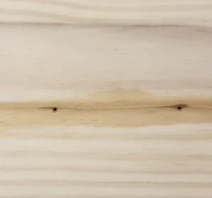 Close up of sanded sign with water damage due to drilling by customer