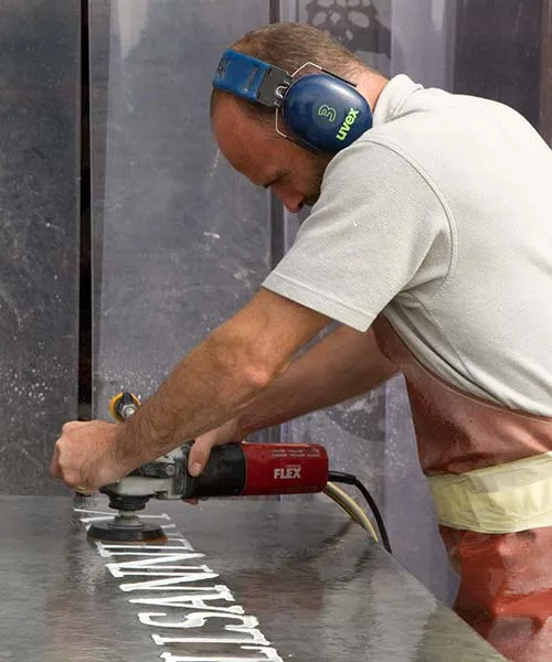 Sign Maker Polishing a Large Slate Sign Polishing a Slate Sign