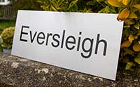 Engraved stainless steel house name plate.