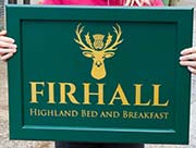 Painted framed sign - gold lettering.
