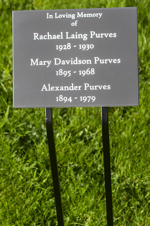 Engraved plaque on wrought iron tree stake.