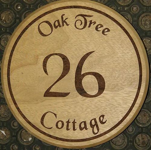round wooden house number sign