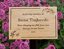 Natural wooden memorial on metal tree stake Natural wooden memorial on metal tree stake