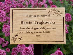 Natural wooden memorial on metal tree stake