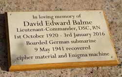 Engraved brass memorial plaque on a backing board.
