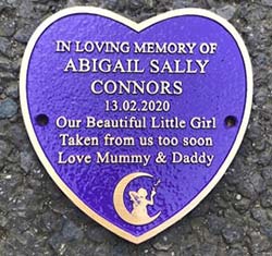 Heart shaped bronze childrens memorial plaque. Heart shaped bronze childrens memorial plaque.