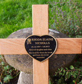 Heart shaped bronze memorial on oak cross