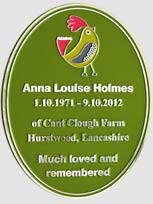 Oval memorial plaque with a green background.