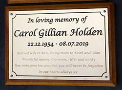 Traditional engraved brass memorial plaque.