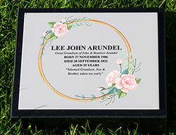 Full colour memorial plaque on black granite wedge.