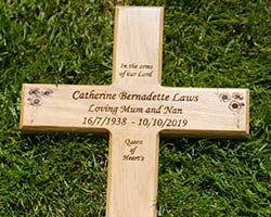 Engraved wooden memorial cross. Engraved wooden memorial cross.