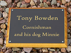 Engraved gold text on black acrylic plaque.