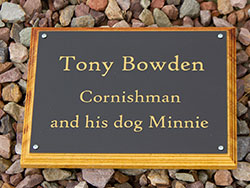 Engraved gold text on black acrylic plaque. Engraved gold text on black acrylic plaque.