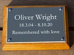 Acrylic laminate memorial plaque mounted on a wooden backing board. Acrylic laminate memorial plaque mounted on a wooden backing board.